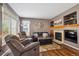 Inviting living room with fireplace, hardwood floors, and comfortable seating at 12705 Home Farm Dr, Westminster, CO 80234