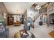 Bright, open living space with a vaulted ceiling, dining area, and staircase featuring elegant wrought iron spindles at 12705 Home Farm Dr, Westminster, CO 80234