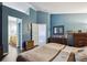 Spacious bedroom with ensuite bath access featuring an open doorway and dark hardwood flooring at 12705 Home Farm Dr, Westminster, CO 80234