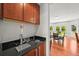 Convenient wet bar area with custom cabinets, sleek countertops, and tap, perfect for entertaining at 6566 S Telluride St, Aurora, CO 80016