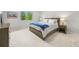 Bedroom featuring natural light, bed, side tables with lamps, and neutral colored walls and carpet at 6566 S Telluride St, Aurora, CO 80016