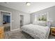 Cozy bedroom with neutral tones, soft carpet, and a sunlit window at 6566 S Telluride St, Aurora, CO 80016