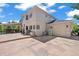 Exterior view of a home featuring a stone patio, outdoor seating, a grill, and an attached garage at 6566 S Telluride St, Aurora, CO 80016