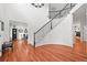 Grand foyer with curved staircase, hardwood floors, and open floor plan at 6566 S Telluride St, Aurora, CO 80016