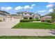 Charming two-story home featuring a three car garage, manicured lawn, and lush landscaping at 6566 S Telluride St, Aurora, CO 80016