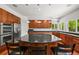 Modern kitchen with stainless steel appliances, wood cabinets, and center island with cooktop at 6566 S Telluride St, Aurora, CO 80016