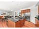 Open concept kitchen with center island, stainless steel appliances, and hardwood floors at 6566 S Telluride St, Aurora, CO 80016