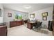 Spacious home office with an abundance of cabinets, built-in shelving, and natural light from large window at 6566 S Telluride St, Aurora, CO 80016
