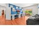 Bright home office with dual workstations, built in shelving, a blue accent wall, and a sliding door to backyard at 6566 S Telluride St, Aurora, CO 80016