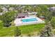 Aerial view of a community pool with a slide, lounge area, and well-maintained landscaping at 6566 S Telluride St, Aurora, CO 80016