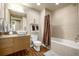 Well-lit bathroom with a modern vessel sink, granite countertops, and a shower-tub combination at 2650 Front View # 205, Denver, CO 80211