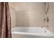 Close-up of a bathtub with stylish tile surround and modern fixtures at 2650 Front View # 205, Denver, CO 80211