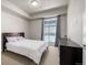 Bedroom featuring a bed, carpeted floor, and a large window at 2650 Front View # 205, Denver, CO 80211