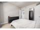 Well-lit bedroom with a queen-sized bed, a dark dresser, and a walk-in closet with built-in organization at 2650 Front View # 205, Denver, CO 80211