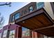 Street view of the building showcasing the address sign at 2650 above the entrance with metal and wood accents at 2650 Front View # 205, Denver, CO 80211