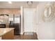 Hallway with hardwood floors, white door, and decorative mirror at 2650 Front View # 205, Denver, CO 80211
