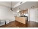 Modern kitchen with a central island, stainless steel appliances, and hardwood flooring at 2650 Front View # 205, Denver, CO 80211
