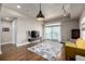 Bright living room featuring hardwood floors, modern lighting, and a sliding glass door to a balcony at 2650 Front View # 205, Denver, CO 80211