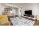 Spacious living room with an open layout and a glimpse of the modern kitchen area at 2650 Front View # 205, Denver, CO 80211