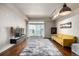 Bright living room featuring hardwood floors, modern lighting, and a sliding glass door to a balcony at 2650 Front View # 205, Denver, CO 80211