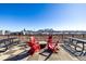 Rooftop deck with red Adirondack chairs, picnic tables, and fantastic city views, perfect for relaxing or entertaining at 2650 Front View # 205, Denver, CO 80211