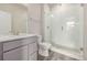 Bright bathroom features a glass shower, modern vanity, and wood-look flooring at 2877 E 103Rd Dr, Thornton, CO 80229