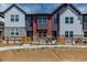 Modern townhomes feature a stone and vinyl facade and a quaint fenced yard at 2877 E 103Rd Dr, Thornton, CO 80229