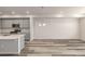 Open-concept kitchen and living area with stainless steel appliances and quartz countertops at 2877 E 103Rd Dr, Thornton, CO 80229