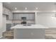 Modern kitchen featuring gray cabinets, a center island with sink, and stainless steel appliances at 2877 E 103Rd Dr, Thornton, CO 80229
