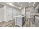 Modern kitchen with stainless steel appliances, a center island with sink, and gray cabinets at 2877 E 103Rd Dr, Thornton, CO 80229