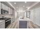 Open kitchen featuring stainless appliances, a center island, gray cabinets, and natural light at 2877 E 103Rd Dr, Thornton, CO 80229