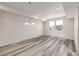 Spacious living room with wood-style flooring, natural light, and elegant lighting fixtures at 2877 E 103Rd Dr, Thornton, CO 80229