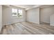 An open living space features plank flooring and two windows at 2877 E 103Rd Dr, Thornton, CO 80229