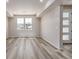 Bright living space with wood-look floors and two large windows at 2877 E 103Rd Dr, Thornton, CO 80229