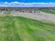 Aerial view of a community overlooking a golf course at 15046 Verbena St, Thornton, CO 80602