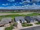 Aerial view showcases neighborhood homes with golf course and open spaces at 15046 Verbena St, Thornton, CO 80602