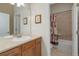 Bright bathroom featuring natural lighting, a large mirror, and a bathtub and shower combination at 15046 Verbena St, Thornton, CO 80602