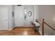 Inviting foyer with hardwood floors and a charming vintage sewing machine table at 15046 Verbena St, Thornton, CO 80602