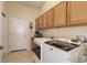 Well-equipped laundry room with upper cabinets and modern washer and dryer for convenience at 15046 Verbena St, Thornton, CO 80602