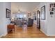 Spacious living room featuring hardwood floors, a fireplace, and ample natural light at 15046 Verbena St, Thornton, CO 80602