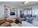 Cozy living room features hardwood floors and built-in shelving at 15046 Verbena St, Thornton, CO 80602