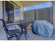 Cozy covered patio with table, chairs, and grill, perfect for outdoor dining and entertaining at 15046 Verbena St, Thornton, CO 80602