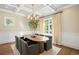 Bright dining room with wood floors, large windows, and coffered ceiling at 285 Elm St, Denver, CO 80220