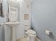 Small half bathroom with pedestal sink and toilet at 12524 Forest Dr, Thornton, CO 80241