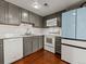 Galley kitchen with gray cabinets and light blue fridge at 12524 Forest Dr, Thornton, CO 80241