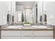 Bathroom with double sink vanity, granite countertop, and large mirror reflecting the shower at 6005 Sandstone Cir, Frederick, CO 80516