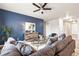 Stylish living room with a large blue accent wall and modern furnishings at 6005 Sandstone Cir, Frederick, CO 80516