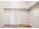 Empty walk-in closet with wood-look flooring, metal shelving, and white walls at 6005 Sandstone Cir, Frederick, CO 80516