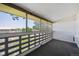 Covered balcony featuring brick accents and view of treelined park at 725 S Alton Way # 7D, Denver, CO 80247