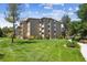 Low-rise building with manicured lawn and mature trees in a quiet neighborhood at 725 S Alton Way # 7D, Denver, CO 80247